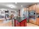 Open kitchen design with a granite island, stainless appliances, and seamless flow to the living area at 3520 Millwater Xing, Dacula, GA 30019