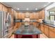 Modern kitchen featuring stainless steel appliances, granite countertops, and a central island at 3520 Millwater Xing, Dacula, GA 30019