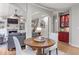 Open-concept living area with fireplace, hardwood floors, and a view of the dining area at 3520 Millwater Xing, Dacula, GA 30019