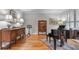 Elegant living room with hardwood floors, piano, and antique furnishings, creating a sophisticated and inviting space at 3520 Millwater Xing, Dacula, GA 30019