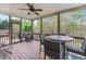 Cozy screened-in porch with seating area, ceiling fan, and view of the backyard at 3520 Millwater Xing, Dacula, GA 30019