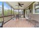 Relaxing screened porch features a ceiling fan and outdoor seating with a view of lush greenery at 3520 Millwater Xing, Dacula, GA 30019