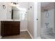 Bathroom featuring a large mirror, updated vanity, and shower/tub combo with white tile at 1184 Red Oak Cv, Tucker, GA 30084