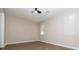 An empty bedroom featuring a ceiling fan, modern vinyl floors, and bright natural light at 1184 Red Oak Cv, Tucker, GA 30084