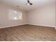 A large bedroom with big windows for natural light and modern vinyl plank flooring at 1184 Red Oak Cv, Tucker, GA 30084