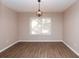 Dining room featuring laminate floors and hanging light fixture at 1184 Red Oak Cv, Tucker, GA 30084