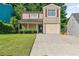 Charming two-story home with a covered front porch and attached garage in a desirable neighborhood at 1184 Red Oak Cv, Tucker, GA 30084