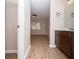 Hallway leading to a bathroom with modern vanity and a bedroom with a closet and plenty of light at 1184 Red Oak Cv, Tucker, GA 30084