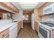 Bright kitchen with white appliances, wood cabinets and quartz countertops at 1184 Red Oak Cv, Tucker, GA 30084