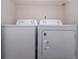 Laundry area with side-by-side white washing machine and dryer at 1184 Red Oak Cv, Tucker, GA 30084