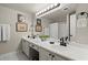 Well-lit bathroom with dual sinks, framed art, and modern fixtures provides a functional space at 2060 Clairmeade Ne Way, Atlanta, GA 30329