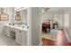 Bright bathroom with dual sinks and ensuite bedroom featuring a wood bed frame and neutral decor at 2060 Clairmeade Ne Way, Atlanta, GA 30329