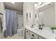 Neat bathroom with a shower, gray curtain, a vanity, and a mirror at 2060 Clairmeade Ne Way, Atlanta, GA 30329