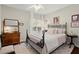 Comfortable bedroom featuring a ceiling fan, decor, and a large window with natural light at 2060 Clairmeade Ne Way, Atlanta, GA 30329