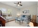 Bright bedroom with a ceiling fan, daybed, and a window bringing in natural light at 2060 Clairmeade Ne Way, Atlanta, GA 30329