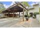 Attached carport featuring a wooden pergola cover and walkway to the cozy townhome's front door at 2060 Clairmeade Ne Way, Atlanta, GA 30329