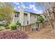 View of the rear exterior featuring a fenced-in yard with greenery and light-gray siding at 2060 Clairmeade Ne Way, Atlanta, GA 30329