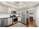 Updated kitchen features stainless steel appliances, white cabinets, and track lighting for modern appeal at 2060 Clairmeade Ne Way, Atlanta, GA 30329