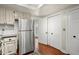 Bright kitchen featuring stainless steel appliances, white cabinetry, and direct access to outdoor space at 2060 Clairmeade Ne Way, Atlanta, GA 30329