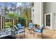 Backyard patio features an outdoor seating area and grill surrounded by a wooden fence at 2060 Clairmeade Ne Way, Atlanta, GA 30329
