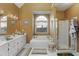 Relaxing primary bathroom with a soaking tub, double vanity, and a separate glass shower at 2415 Carina Nw Ter, Acworth, GA 30101