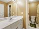 Bathroom featuring a white vanity, a large mirror, and a toilet at 2415 Carina Nw Ter, Acworth, GA 30101