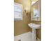 Charming powder room with pedestal sink, decorative mirror, and neutral color scheme at 2415 Carina Nw Ter, Acworth, GA 30101