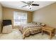 Cozy bedroom with neutral walls, large window, ceiling fan, and comfortable furnishings at 2415 Carina Nw Ter, Acworth, GA 30101