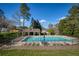 Community pool surrounded by lounge chairs and lush greenery, offering a relaxing atmosphere for residents at 2415 Carina Nw Ter, Acworth, GA 30101