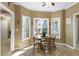 Eat-in kitchen featuring laminate flooring, natural light, and access to other rooms for an open and accessible space at 2415 Carina Nw Ter, Acworth, GA 30101