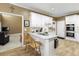 Kitchen featuring granite counters, white cabinets, stainless steel appliances, and laminate flooring for a sleek and modern space at 2415 Carina Nw Ter, Acworth, GA 30101
