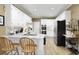 Kitchen featuring laminate flooring, white cabinets, granite counters, and stainless steel appliances for modern convenience at 2415 Carina Nw Ter, Acworth, GA 30101