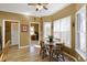 Eat-in kitchen featuring laminate flooring, natural light, a ceiling fan, and access to other rooms for an open feel at 2415 Carina Nw Ter, Acworth, GA 30101