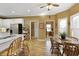 Eat-in kitchen featuring laminate flooring, stainless steel appliances, granite counters, white cabinets, and plenty of natural light at 2415 Carina Nw Ter, Acworth, GA 30101