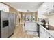 Well-lit kitchen boasts granite countertops, modern appliances, and an adjacent breakfast nook at 2415 Carina Nw Ter, Acworth, GA 30101