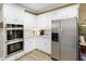 This kitchen features double ovens, stainless steel refrigerator, and ample white cabinets at 2415 Carina Nw Ter, Acworth, GA 30101