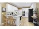 Kitchen featuring laminate flooring, granite counters, white cabinets, and stainless steel appliances for a modern look at 2415 Carina Nw Ter, Acworth, GA 30101