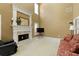 Inviting living room with a fireplace, neutral carpet, comfortable seating, and plenty of natural light from the window at 2415 Carina Nw Ter, Acworth, GA 30101