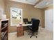 A home office offers a comfortable workspace with natural light and a view of the backyard at 2415 Carina Nw Ter, Acworth, GA 30101