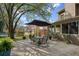 Outdoor patio features a dining table under an umbrella and overlooks the landscaped backyard at 2415 Carina Nw Ter, Acworth, GA 30101