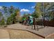 Playground with slides, swings, and a climbing wall, surrounded by lush greenery at 2415 Carina Nw Ter, Acworth, GA 30101