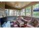Relaxing sunroom filled with windows, wicker furniture and ceiling fan at 2415 Carina Nw Ter, Acworth, GA 30101