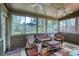 Cozy sunroom with wicker furniture, a ceiling fan, and lots of windows overlooking the backyard at 2415 Carina Nw Ter, Acworth, GA 30101