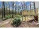 View of backyard and woods with a newly constructed wooden deck at 6175 Knights Ln, Douglasville, GA 30135