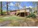 View of backyard with a newly constructed wooden deck attached to the brick home at 6175 Knights Ln, Douglasville, GA 30135