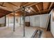 This basement offers unfinished potential with exposed wood ceiling and support pillars at 6175 Knights Ln, Douglasville, GA 30135
