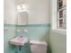 This quaint bathroom has vintage aqua and green tiles with a sink and toilet at 6175 Knights Ln, Douglasville, GA 30135