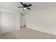 A bright bedroom with carpeted floors, a ceiling fan, and a closet offers lots of storage at 6175 Knights Ln, Douglasville, GA 30135