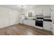 Clean, minimalist kitchen featuring white cabinets, laminate countertops and modern flooring at 6175 Knights Ln, Douglasville, GA 30135