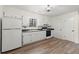 Bright kitchen featuring white cabinets, laminate countertops and modern flooring at 6175 Knights Ln, Douglasville, GA 30135
